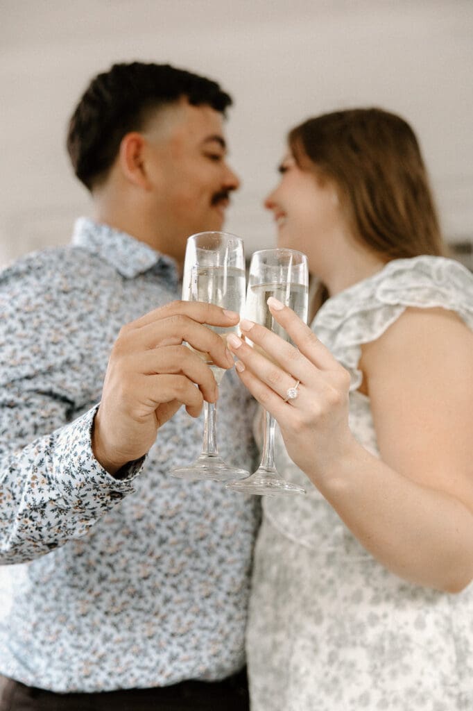 Arlington hall dallas engagement photos champange glasses ring shot