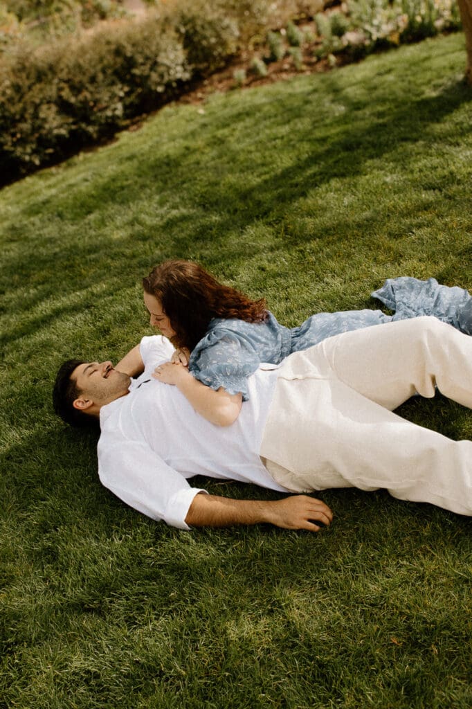 Dallas arboretum engagement photos laying in field