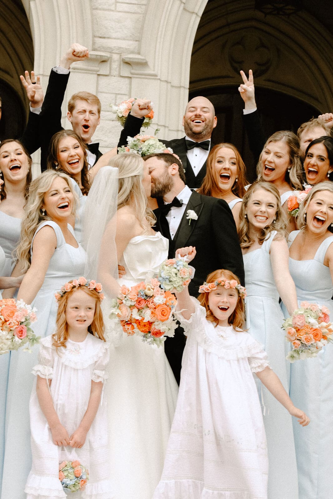 bridal party cheering for the married bride and groom at this beautiful luxury dallas wedding at the Warwick Hotel